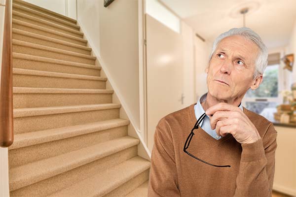 elderly man thinking about a stairlift
